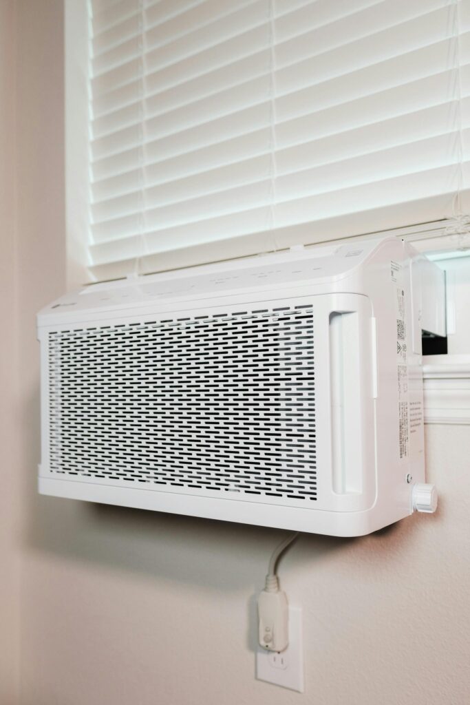 pexels-photo-16592625-16592625 Wall-mounted air conditioner installed in a residential setting, providing cooling comfort.